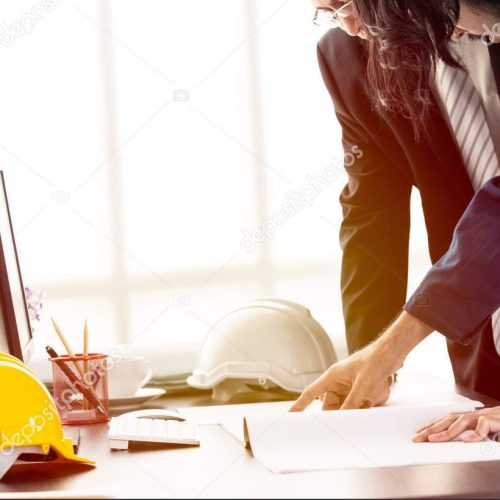 Asian executive engineer and young engineer discuss about blueprint in modern office, concept for discuss about blueprint in modern office.