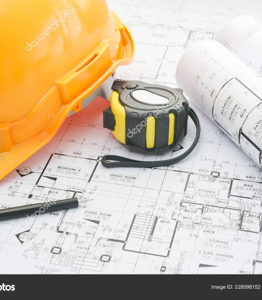 architects workplace - architectural blueprints with measuring t architects workplace - architectural blueprints with measuring tape, safety helmet and tools on table. top view